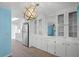 Open kitchen layout with stainless steel appliances, white cabinets, and modern lighting at 891 Grado Dr, Venice, FL 34285