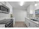Modern kitchen featuring stainless steel appliances, white countertops, and sleek white cabinetry at 891 Grado Dr, Venice, FL 34285