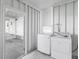 White laundry room with a washer and dryer next to the door at 891 Grado Dr, Venice, FL 34285