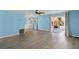 Bright living room featuring blue walls, light wood floors, built-ins, and slider to the porch at 891 Grado Dr, Venice, FL 34285