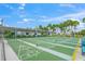 Outdoor shuffleboard courts offer a fun recreational activity amid lush greenery under the bright sunny sky at 891 Grado Dr, Venice, FL 34285
