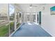 Spacious sunroom with plenty of light and glass windows, and blue carpet at 891 Grado Dr, Venice, FL 34285