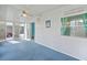 Enclosed sunroom with bright blue carpet, with many windows providing plenty of light at 891 Grado Dr, Venice, FL 34285
