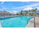 Sparkling swimming pool surrounded by lush palm trees, providing a refreshing oasis for residents to enjoy on sunny days at 891 Grado Dr, Venice, FL 34285