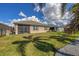 The backyard is surrounded by a black metal fence, and it leads to a screened in patio at 8969 Mondial Ct, Venice, FL 34293