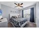 Cozy bedroom featuring a ceiling fan, plush carpet, and coastal-themed decor at 8969 Mondial Ct, Venice, FL 34293