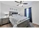 Relaxing bedroom featuring a ceiling fan, plush carpet, and nautical-themed decor at 8969 Mondial Ct, Venice, FL 34293
