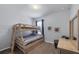 Cozy bedroom featuring a wooden bunk bed with striped bedding, nautical decor, and carpeted floors at 8969 Mondial Ct, Venice, FL 34293
