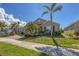 Charming single-story home with lush landscaping, manicured lawn, and a brick driveway at 8969 Mondial Ct, Venice, FL 34293