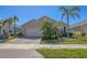 Charming single-story home with a well-manicured lawn and a paver driveway leading to a two-car garage at 8969 Mondial Ct, Venice, FL 34293