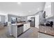 Open-concept kitchen featuring a center island with bar seating, stainless steel appliances, and tile flooring at 8969 Mondial Ct, Venice, FL 34293