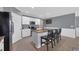 Charming kitchen with a large island, granite countertops, stainless steel appliances, and white cabinetry at 8969 Mondial Ct, Venice, FL 34293