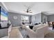 Bright living room with a ceiling fan, decorative rug, and stylish furnishings at 8969 Mondial Ct, Venice, FL 34293