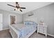 This main bedroom is a serene retreat with plush carpet, ceiling fan, and ensuite bathroom at 8969 Mondial Ct, Venice, FL 34293
