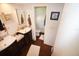 Bathroom with dual sinks, and a separate toilet area at 9 Windsor Dr, Englewood, FL 34223