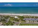 Aerial view showcases the beautiful beach and park amenities, surrounded by parking and lush greenery near the ocean at 902 Gibbs Rd # 181, Venice, FL 34285