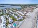 Panoramic aerial view of a beachfront property with beach access, a pool, and a well-maintained landscape at 902 Gibbs Rd # 181, Venice, FL 34285