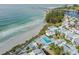 An aerial view of condos near a beautiful beach featuring a community pool at 902 Gibbs Rd # 181, Venice, FL 34285