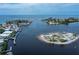This aerial shows community condos near a marina and open ocean access on a clear day at 902 Gibbs Rd # 181, Venice, FL 34285