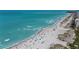 Expansive beach view with turquoise water, sandy shore, and scattered beachgoers enjoying a sunny day at 902 Gibbs Rd # 181, Venice, FL 34285