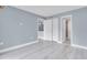 Spacious room with light floors, a storage closet, and doorways to kitchen and bathroom at 902 Gibbs Rd # 181, Venice, FL 34285