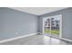 A simple bedroom with sliding glass doors opening to a waterfront view at 902 Gibbs Rd # 181, Venice, FL 34285