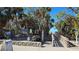 A boardwalk with a turtle sculpture leads to beautiful Venice Beach, adorned with lush palm trees at 902 Gibbs Rd # 181, Venice, FL 34285