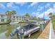 Waterfront condo complex with canal, boat docks, and meticulous landscaping with tropical palm trees at 902 Gibbs Rd # 181, Venice, FL 34285