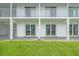 Building's exterior with sliding glass doors to each condo, and a well-maintained lawn at 902 Gibbs Rd # 181, Venice, FL 34285