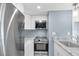Updated kitchen with stainless steel appliances, white cabinets, and light countertops for a modern aesthetic at 902 Gibbs Rd # 181, Venice, FL 34285