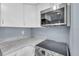 A close-up of a modern kitchen with stainless steel appliances and white cabinets at 902 Gibbs Rd # 181, Venice, FL 34285
