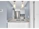 Well-lit kitchen with stainless steel appliances, sink, and overhead lighting at 902 Gibbs Rd # 181, Venice, FL 34285