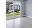 Bright room with light floors, sliding glass doors, and exterior views at 902 Gibbs Rd # 181, Venice, FL 34285