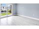 Bright room with light floors, blueish grey walls, and sliding doors with a view at 902 Gibbs Rd # 181, Venice, FL 34285