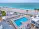 Relaxing pool area with comfortable seating, umbrella tables, and convenient beach access at 902 Gibbs Rd # 181, Venice, FL 34285