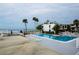 Inviting pool area featuring a large pool, ample seating, and glimpses of the ocean nearby at 902 Gibbs Rd # 181, Venice, FL 34285