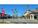 Street view featuring palm tree-lined street with shops, restaurants, and blue skies in the vibrant Venice community at 902 Gibbs Rd # 181, Venice, FL 34285
