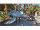 A turtle sculpture sits on the path to Venice Beach surrounded by beautiful greenery and walkways at 902 Gibbs Rd # 181, Venice, FL 34285
