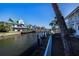 Waterfront condo community on a canal with docks and boat access, set against a clear blue sky at 902 Gibbs Rd # 181, Venice, FL 34285