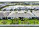 Aerial view of a stunning neighborhood with lush landscaping, community amenities, and beautiful lake views at 9916 Bright Water Dr, Englewood, FL 34223