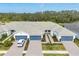An aerial view of a well-maintained single-story home with a spacious driveway and green landscaping at 9916 Bright Water Dr, Englewood, FL 34223