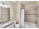 Bathroom featuring tub with shower, granite vanity, and neutral color palette at 9916 Bright Water Dr, Englewood, FL 34223