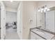 Bathroom featuring granite vanity, decorative lighting, and stylish fixtures at 9916 Bright Water Dr, Englewood, FL 34223