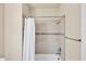 Cozy bathroom featuring shower and tub combination and stylish towel rack at 9916 Bright Water Dr, Englewood, FL 34223
