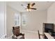 Cozy room featuring a ceiling fan, plantation shutters and a chair with desk at 9916 Bright Water Dr, Englewood, FL 34223