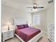 Bedroom featuring a bed, dresser, nightstands, and shuttered windows at 9916 Bright Water Dr, Englewood, FL 34223