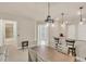 Bright dining area with a modern table, bar seating and entry to the house at 9916 Bright Water Dr, Englewood, FL 34223