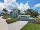 Community entrance featuring a water feature, landscaping, and Beachwalk signage at 9916 Bright Water Dr, Englewood, FL 34223