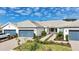Well-maintained single-story home with a two-car garage and manicured landscaping at 9916 Bright Water Dr, Englewood, FL 34223