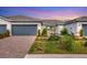 Charming single-story home with a neatly landscaped front yard and a two-car garage at 9916 Bright Water Dr, Englewood, FL 34223